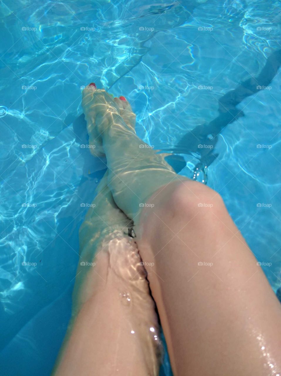 girl legs in the pool