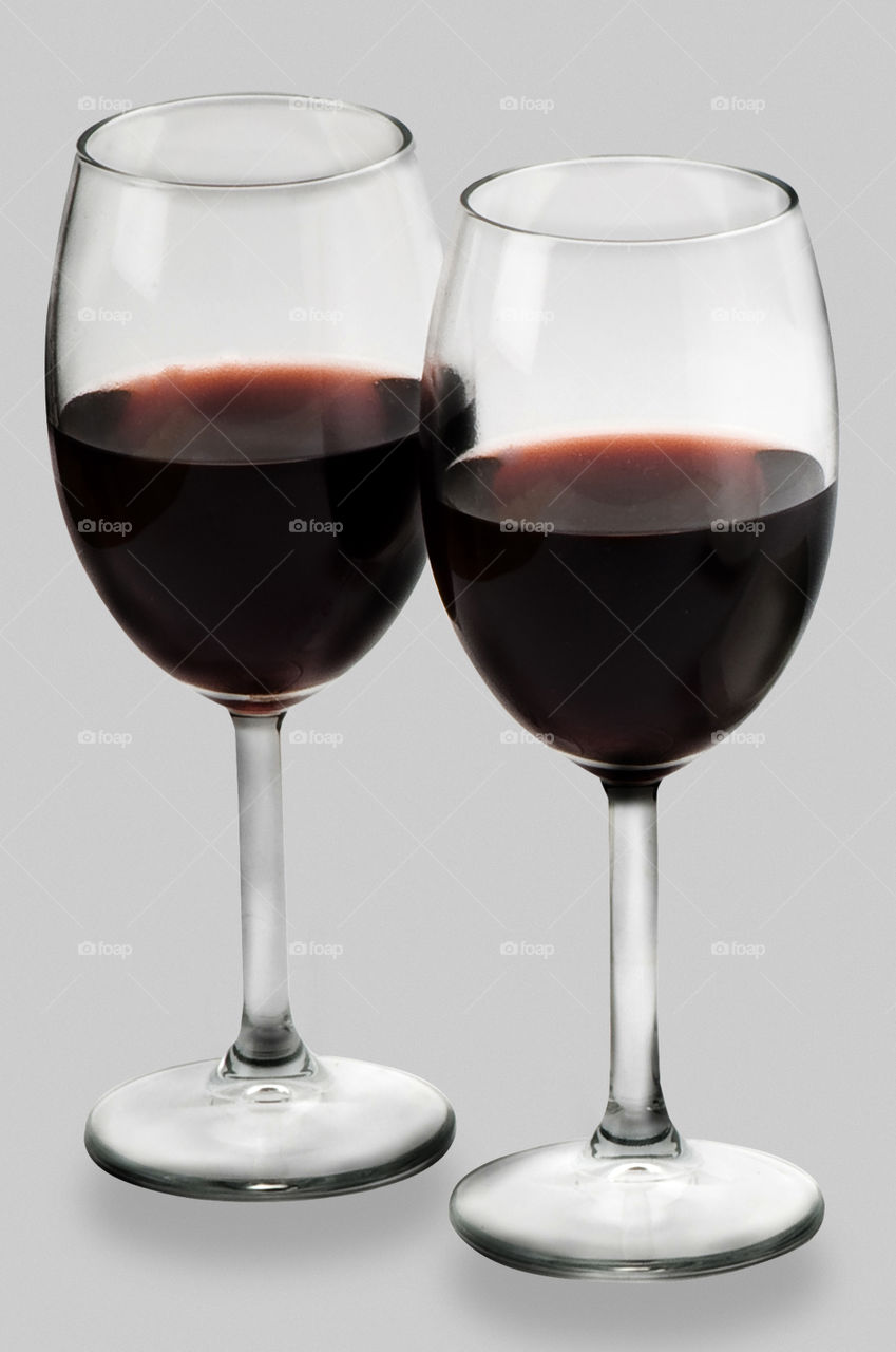 glasses of red wine on white background