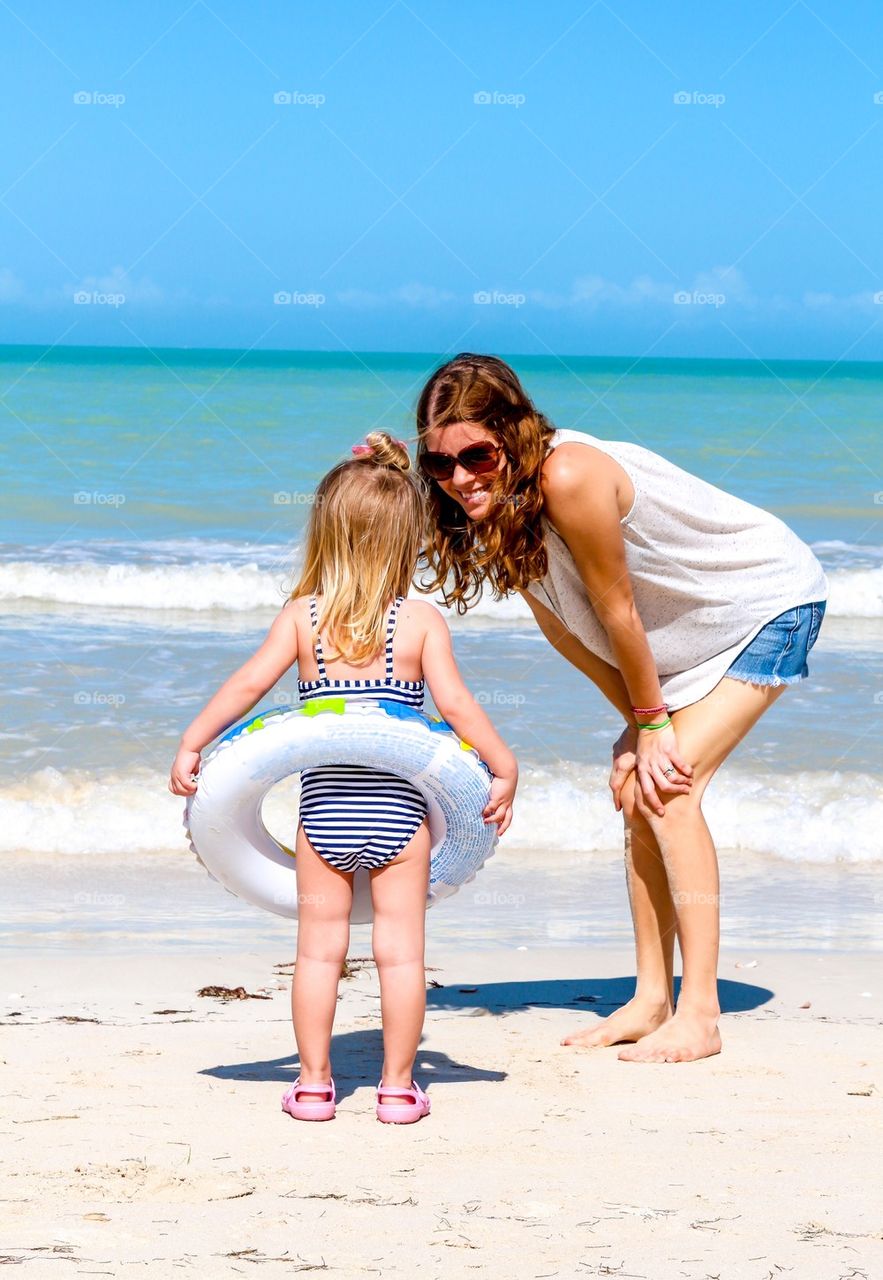 Mom daughter having fun on a Yucatan beach