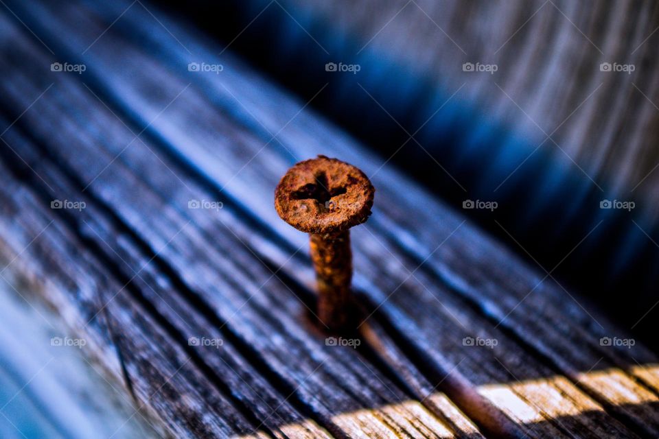 rusty nail in an old board