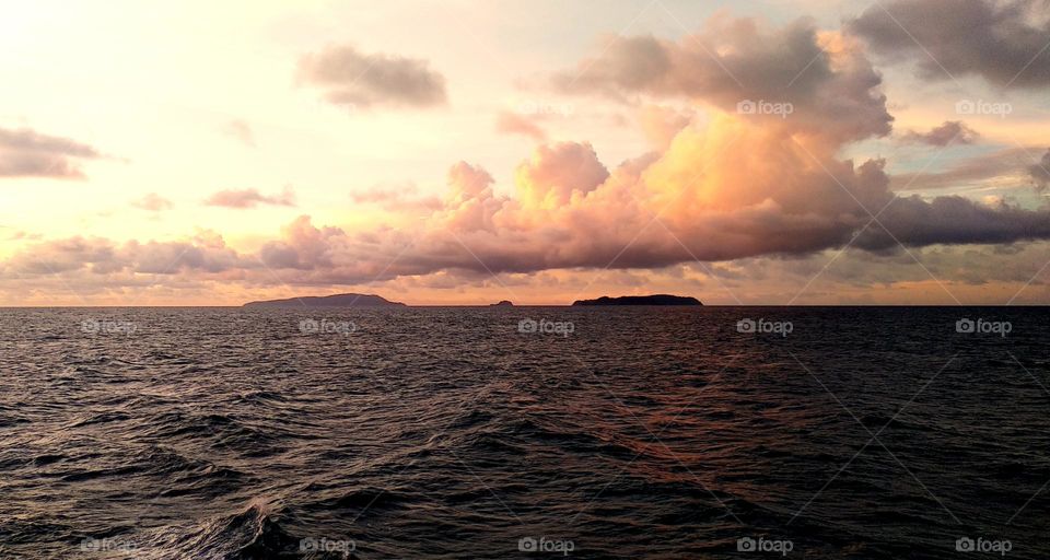 View of clouds over small islands and sea in the afternoon.