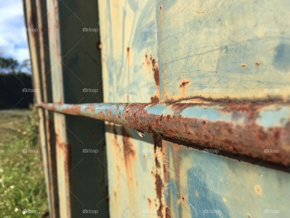 Along side a metal dumpster 