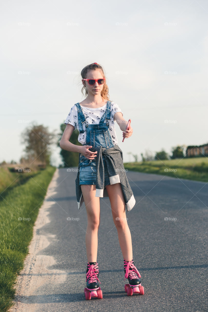 Young girl riding on roller skates. Real people, authentic situations