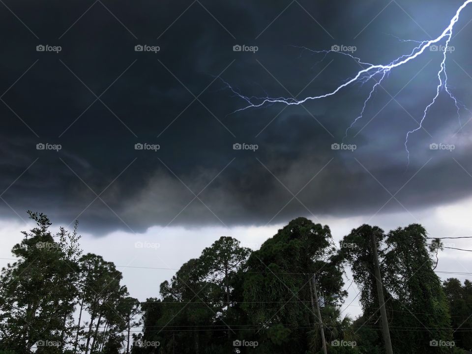 Lightning strikes through a dark impending thunderstorm.