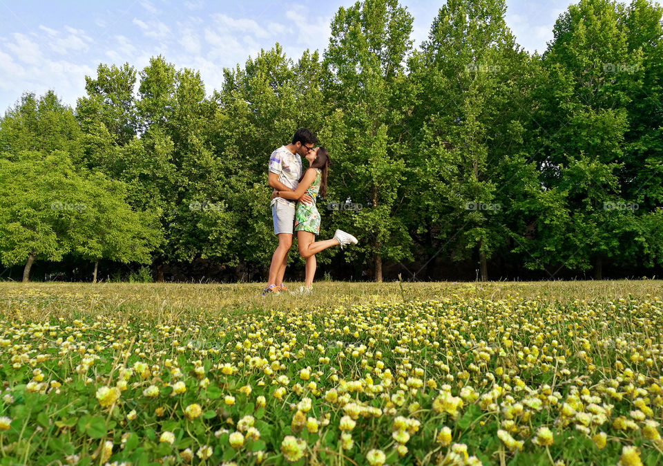 Couple kissing on a natural park.