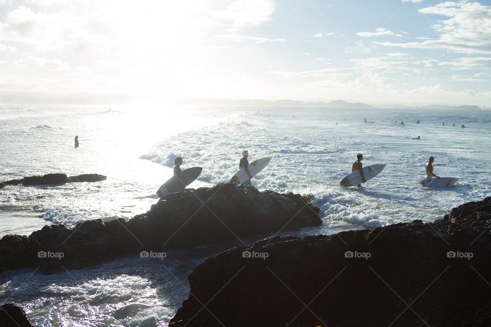 Surfers heading into the beach