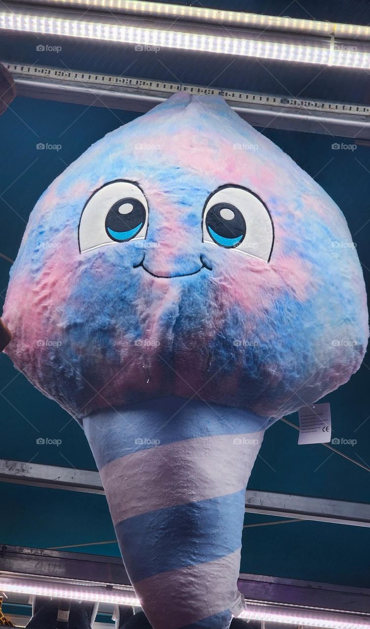 happy smiling blue and pink cotton candy sweet treat plush carnival game toy prize at an Oregon fair in Summer