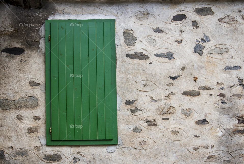 Green window on old house wall