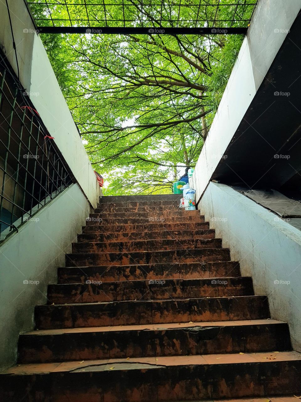 Stairs in the parking lot under the city park, Bandung Indonesia, conventional stair, climbing the stairs on foot, limited by railings, view inside thr parking, urban park parking lots, view inside the underground parking lots