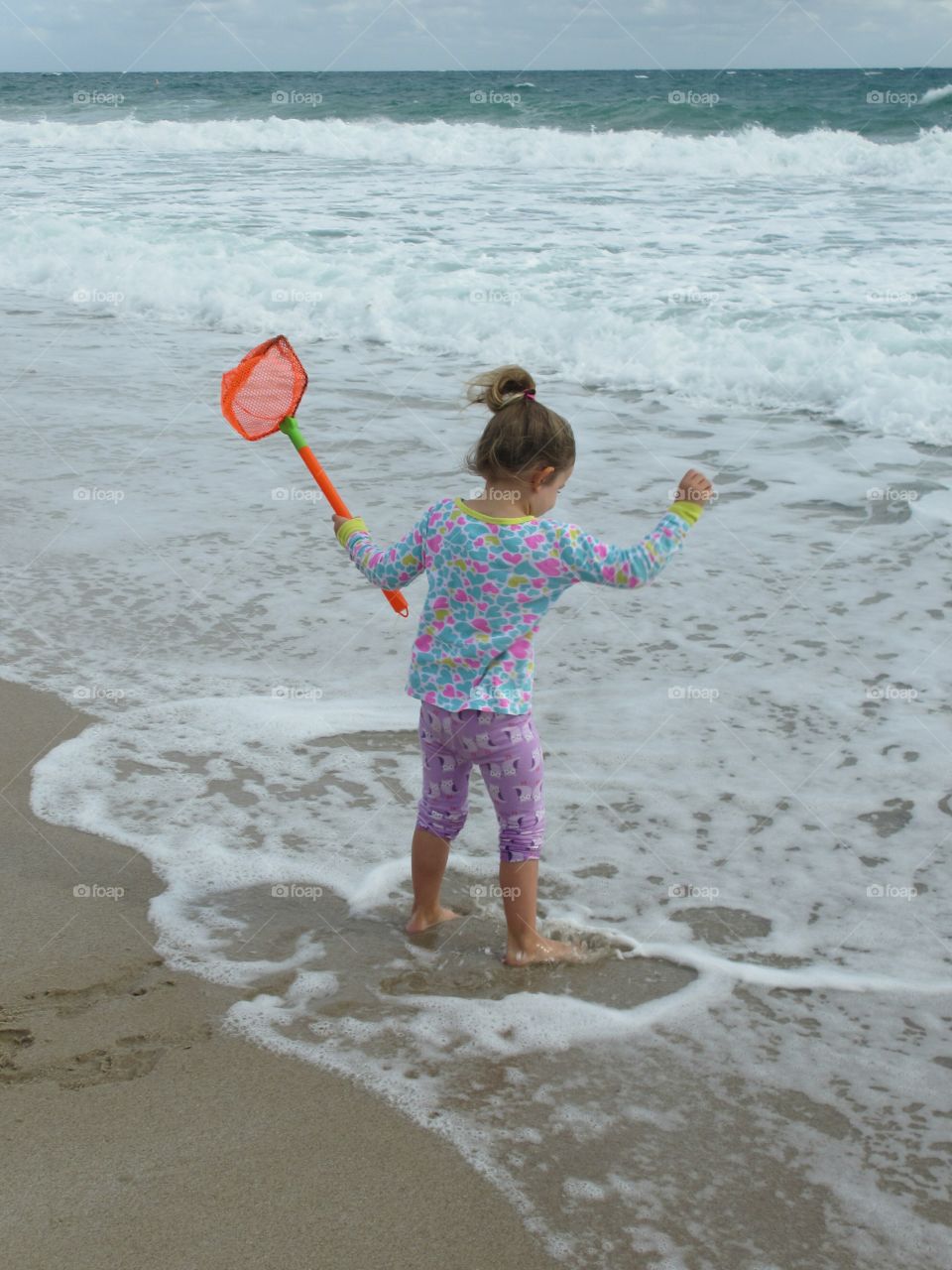 Young girl playing at the beach