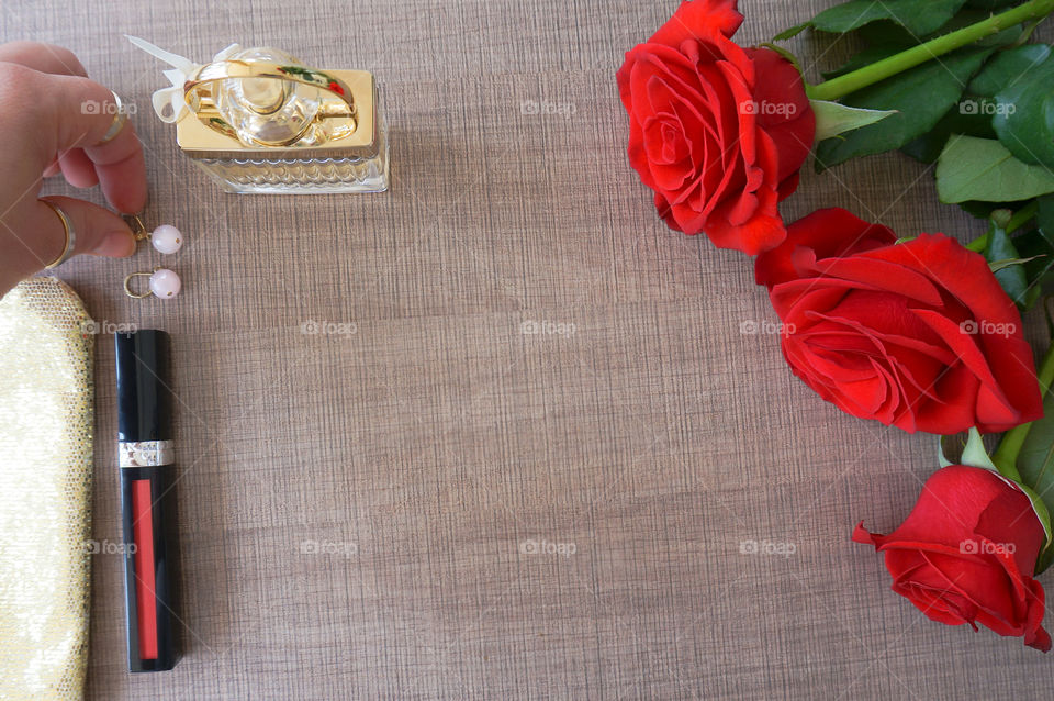 Flat lay of roses and cosmetics, copy space