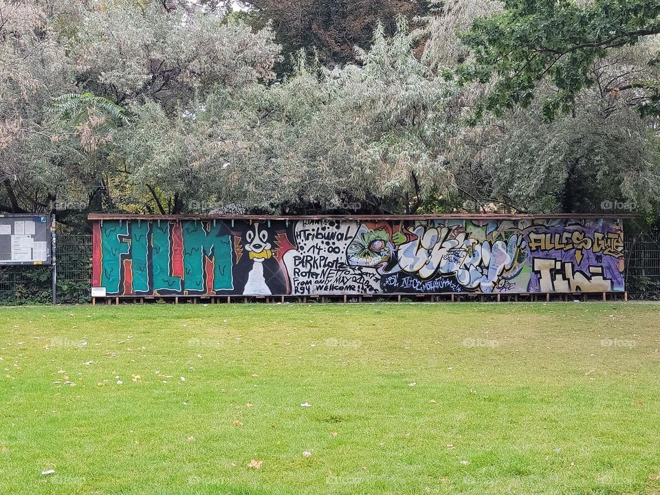 Sitting in the park, you get to look at the latest graffiti while relaxing.