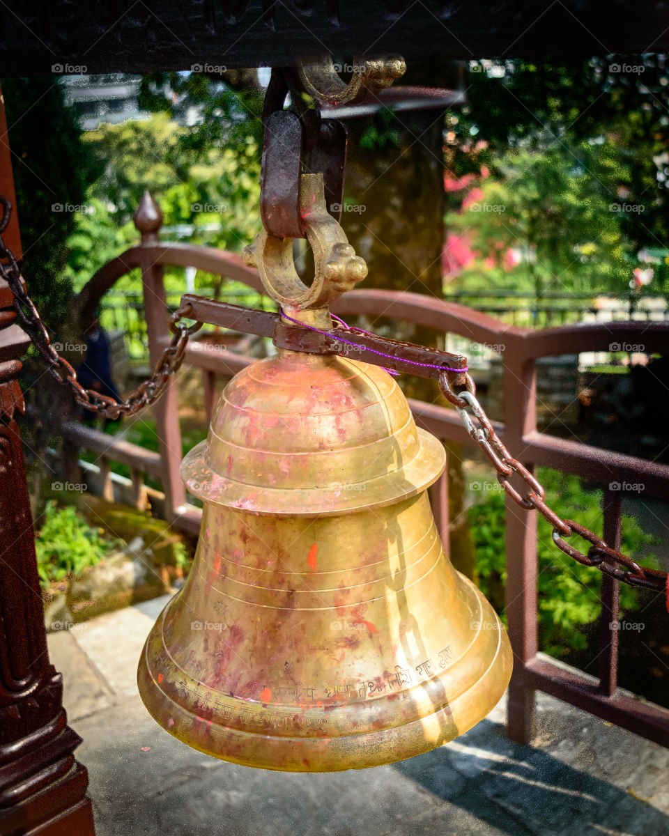 In Hinduism, bells are generally hung at temple dome. Devotees ring bell while entering sanctum. Sound is considered auspicious which welcomes divinity and dispels evil.