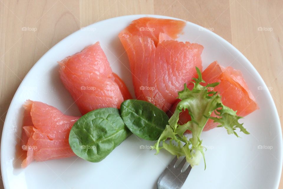 Raw food in plate on table