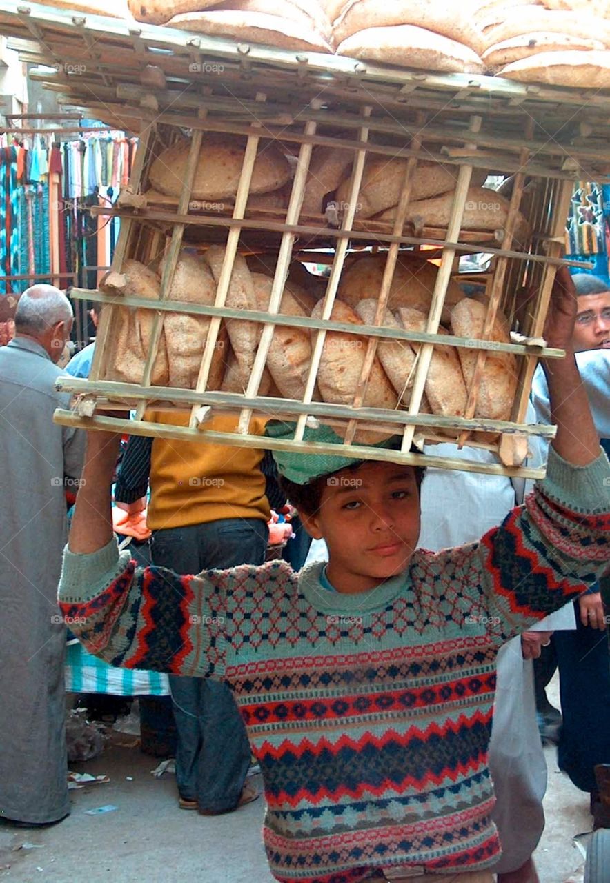 Delivery boy in Cairo, Egypt. Boy delivering fresh pita bread to a restaurant in Cairo, Egypt