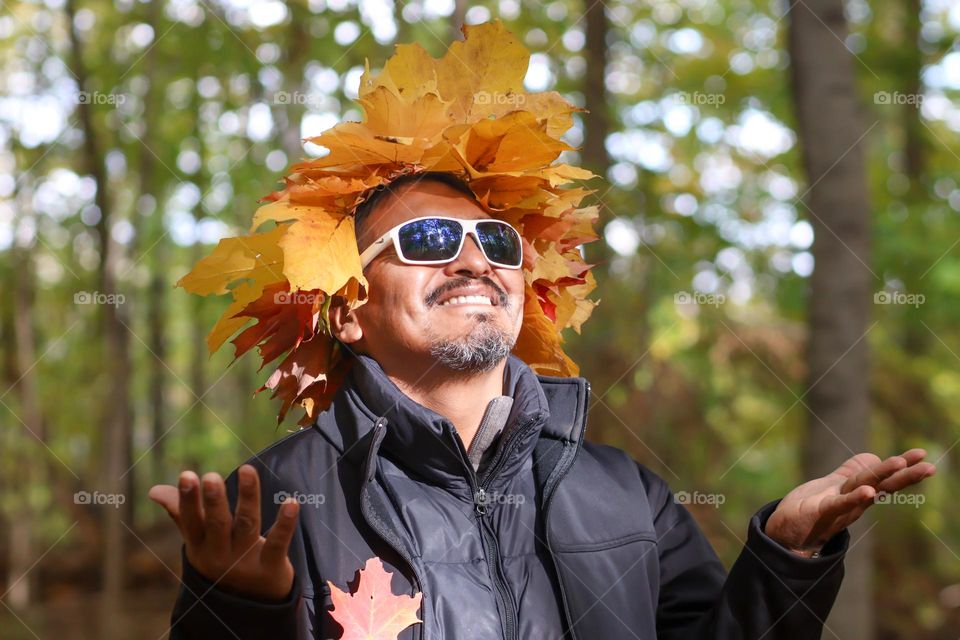 Happy man in a autumn leaves' crown