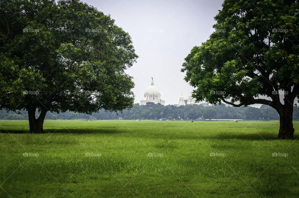 Beautiful image of Victoria Memorial snap from distance, from Moidan, Kolkata , Calcutta, West Bengal, India. A Historical Monument, large marble building dedicated to memory of Queen Victoria.