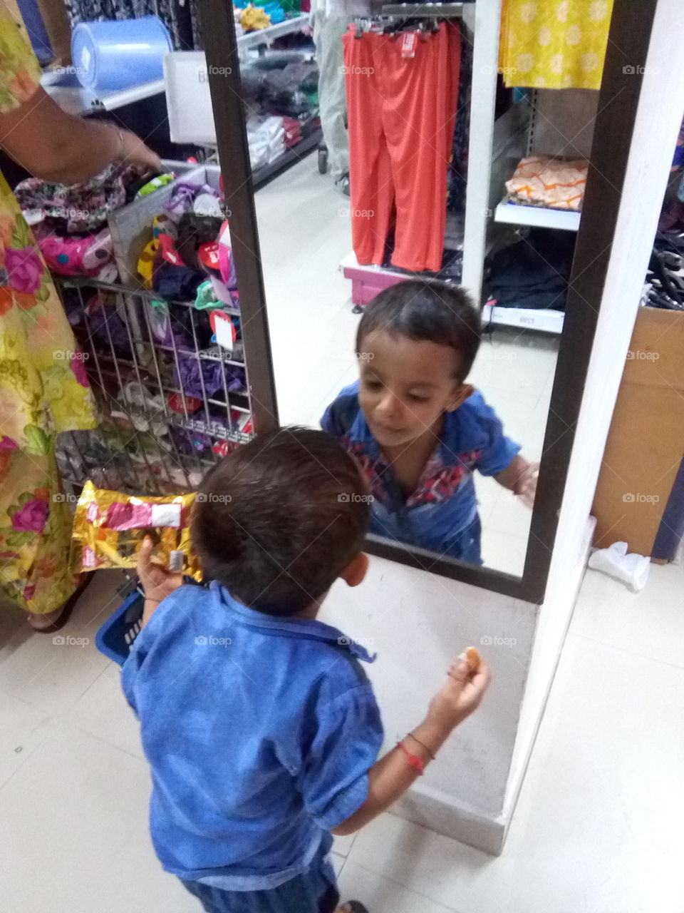Little boy playing with mirror