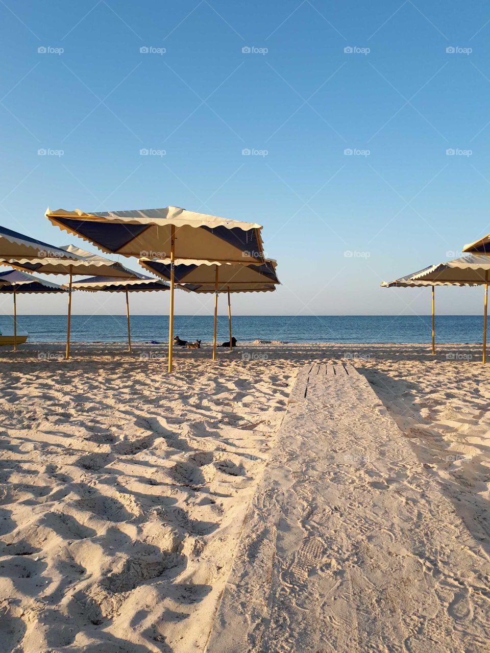 Wooden bridge to the sand beach