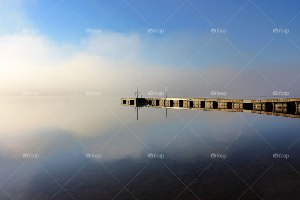 Reflection on the water in foggy morning