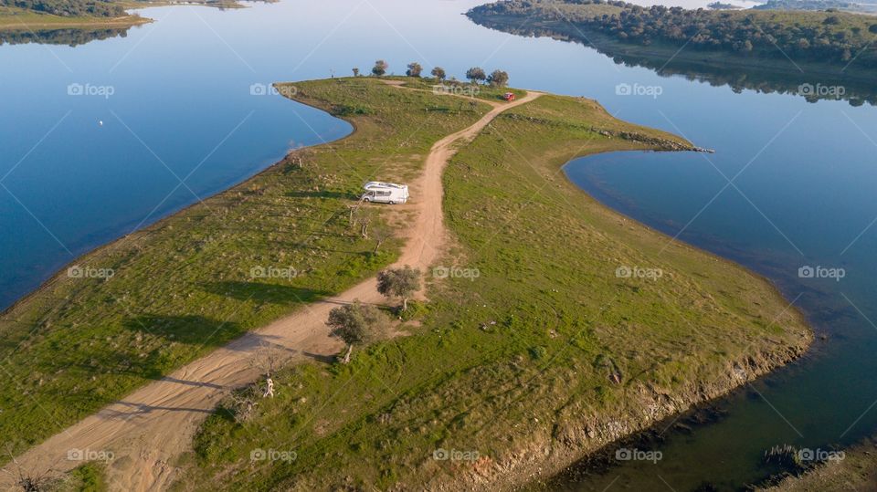 Aerial view of a lonely camping car on a island 