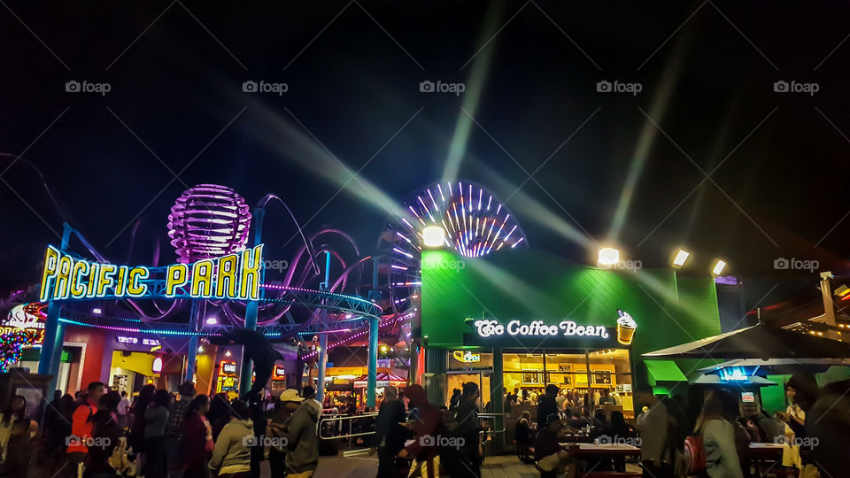 The Santa Monica Pier in LA, California at night is a bright sight to behold.