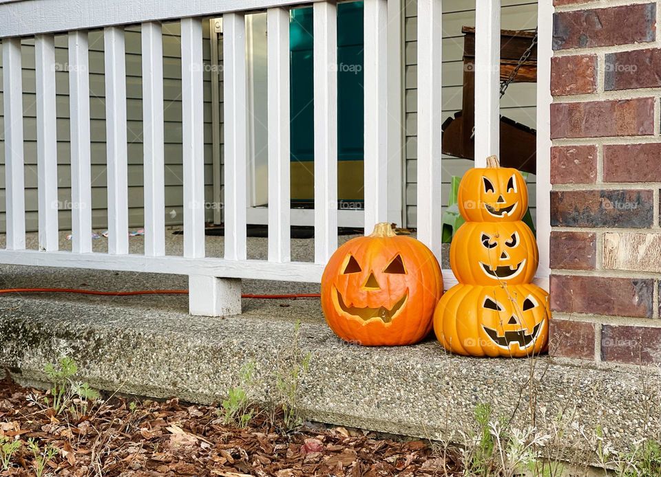 Pumpkins lanterns on the house porch 