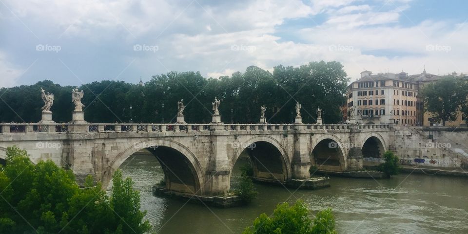 The beautiful and historic Ponte Sant'Angelo in Rome, Italy.  This Roman bridge over the Tiber River as see on a summer’s day in June.