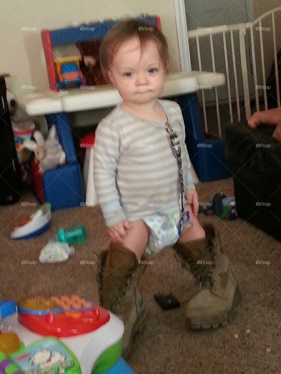 In Daddy's boots. My grandson is wearing his daddy's work boots