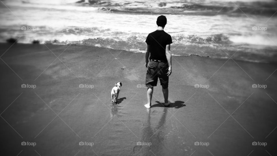 Reflect. lovce this photo of my oldest walking the beach with his jack