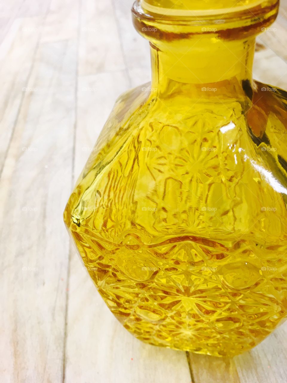 This capture is a representation of a yellow glass bottle.