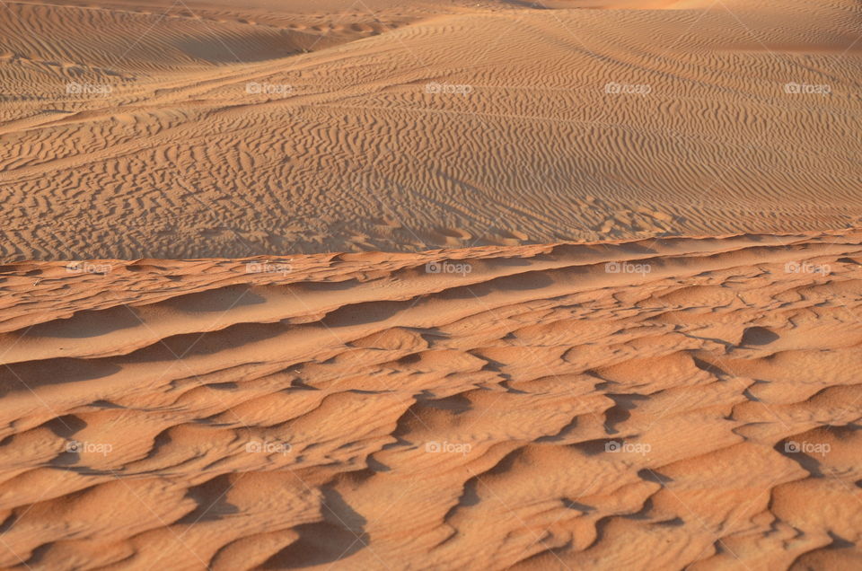 The beautiful blood orange sands are found in the heart of the desert in the middle of the hot summer in Middle East. 