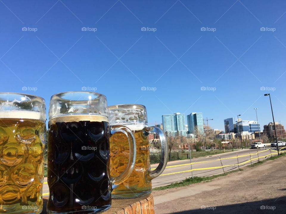Beer against the Denver skyline