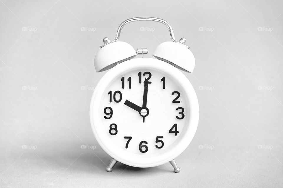 Alarm clock isolated on gray background 