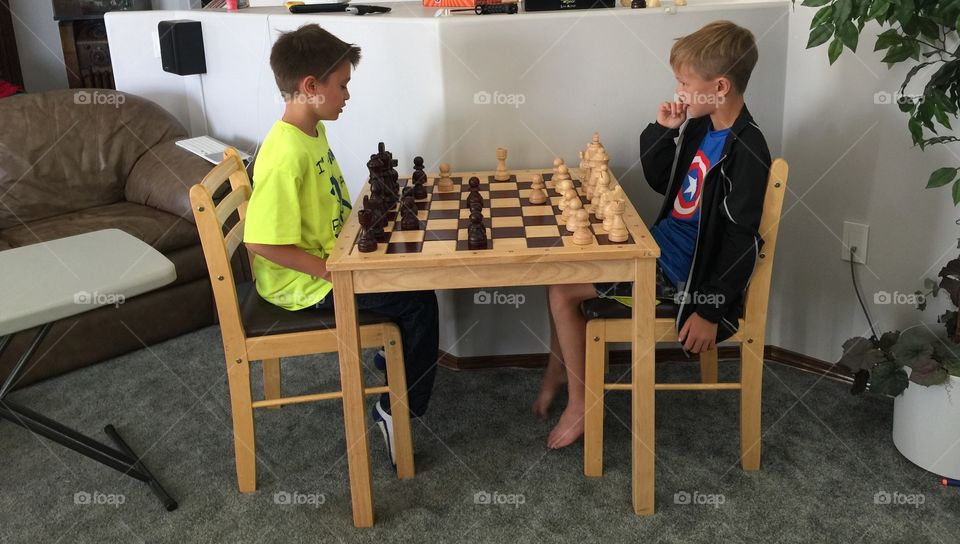 The boys enjoying a game of chess
