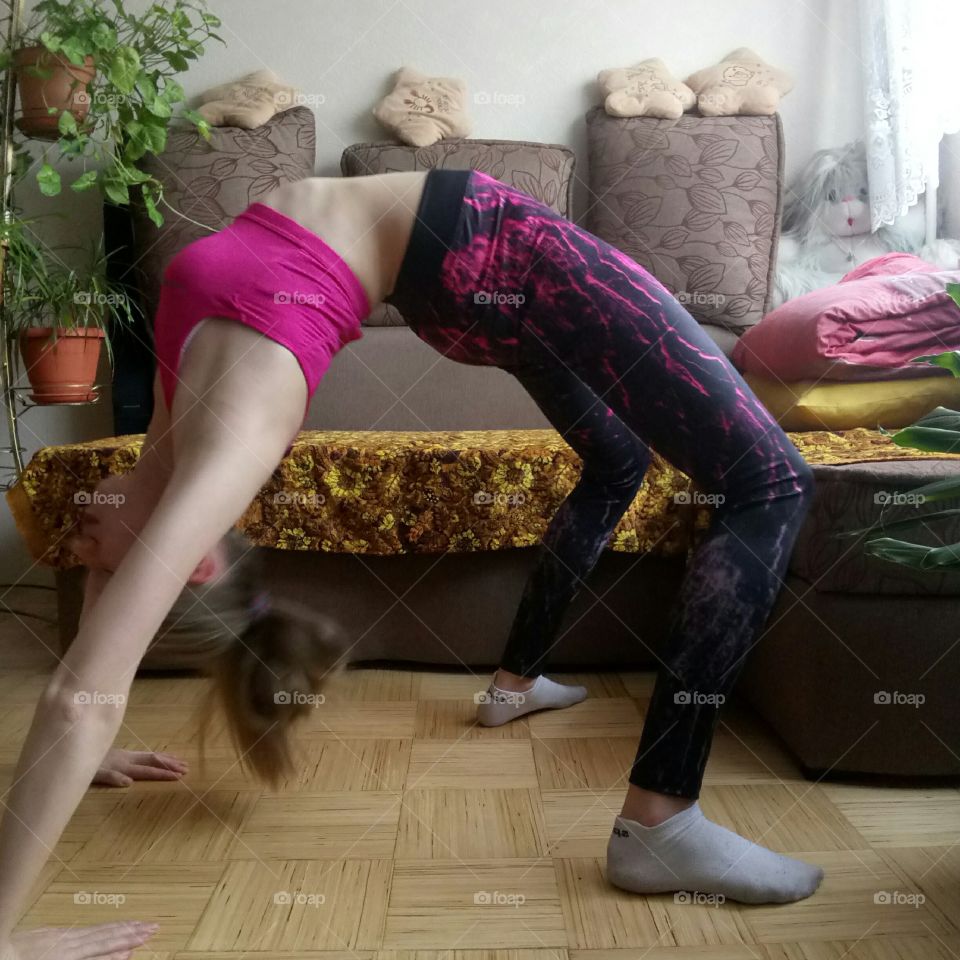 Young woman doing yoga in house