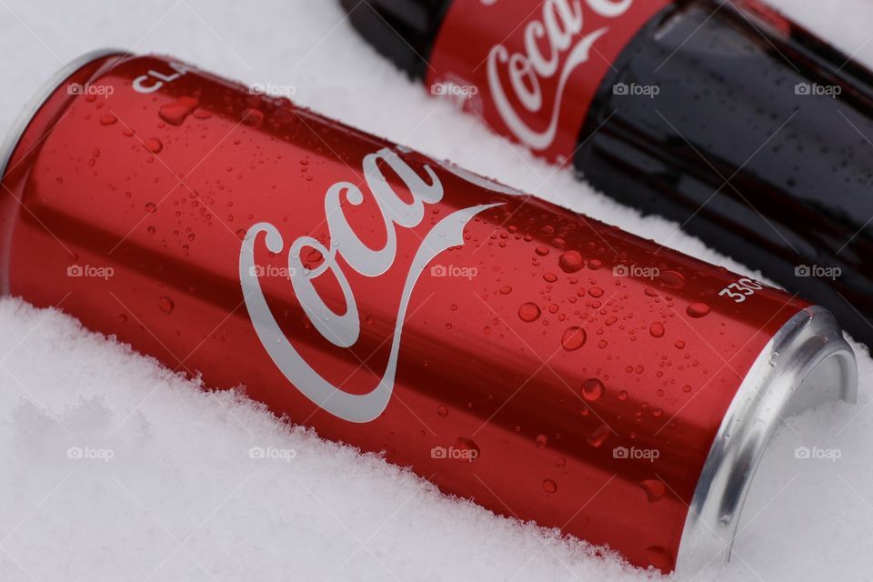 Coca-Cola in a metal can on the snow