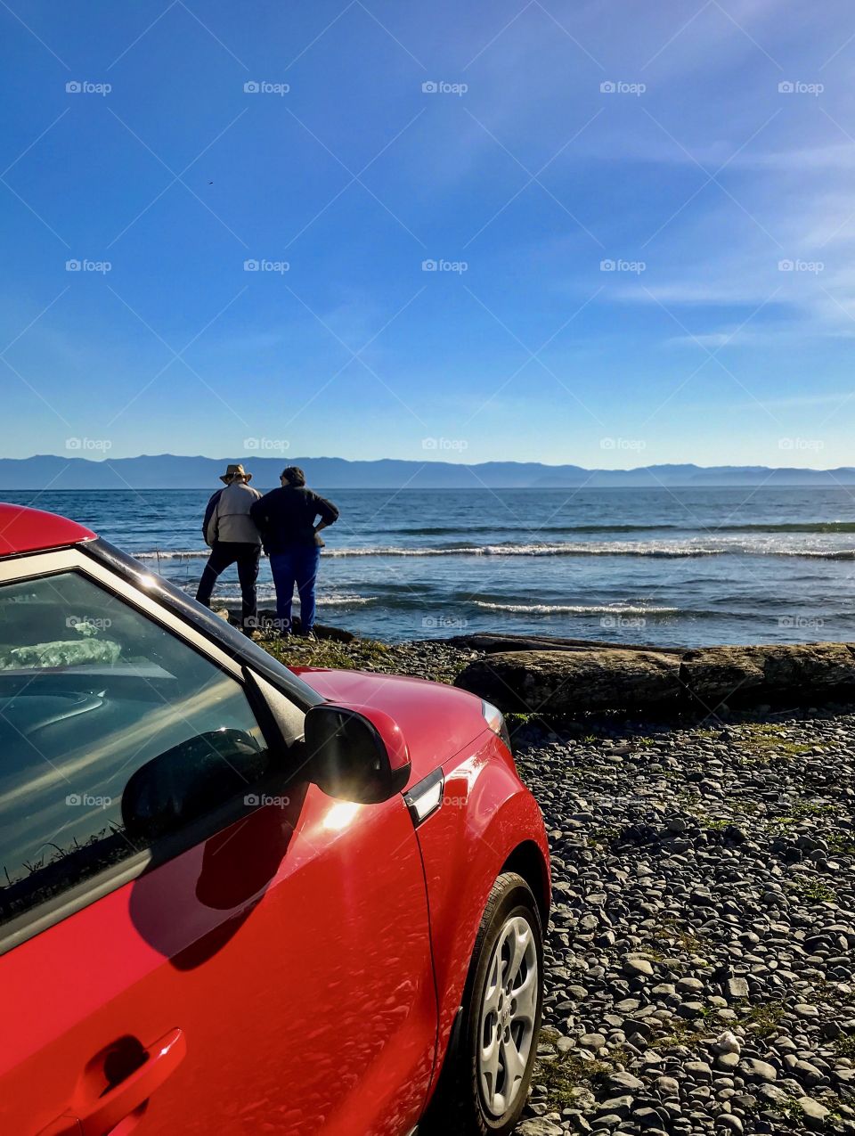 Driving to the seaside - small red car is a favourite mode of transportation