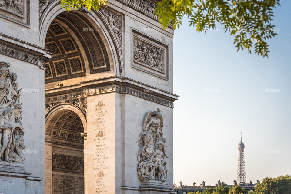 Close up on the Arch of Triumph with the Eiffel Tower in background, Paris France 