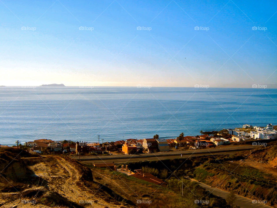 tijuana mexico sunset buildings coastline by refocusphoto