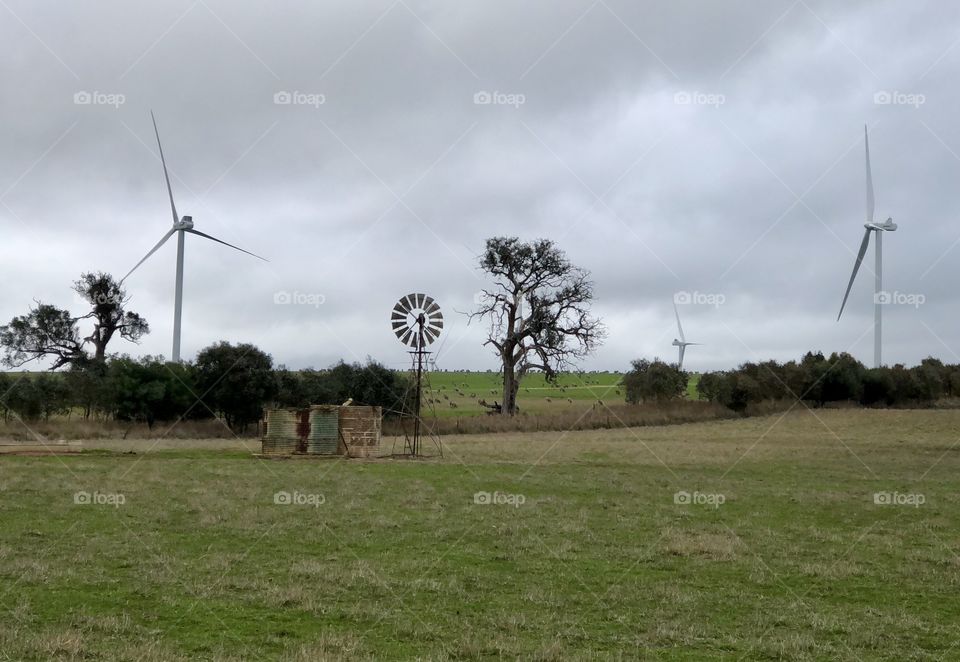Changing of the guard. Wind turbines replacing windmills in rural Victoria, Australia 