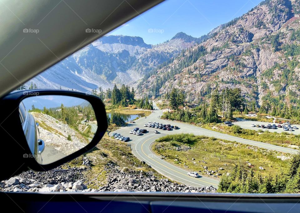 View from car window to the parking area in the mountains 