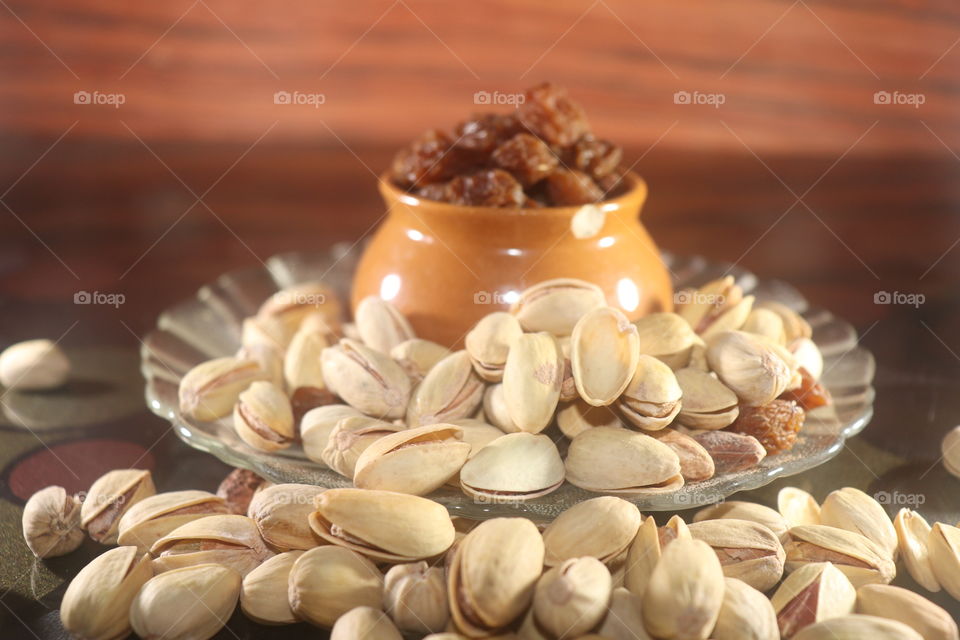Crisp and pistachios in a small plate and cup