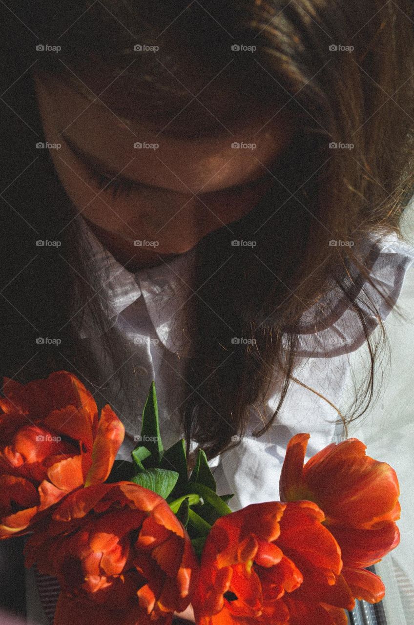 The girl is holding flowers