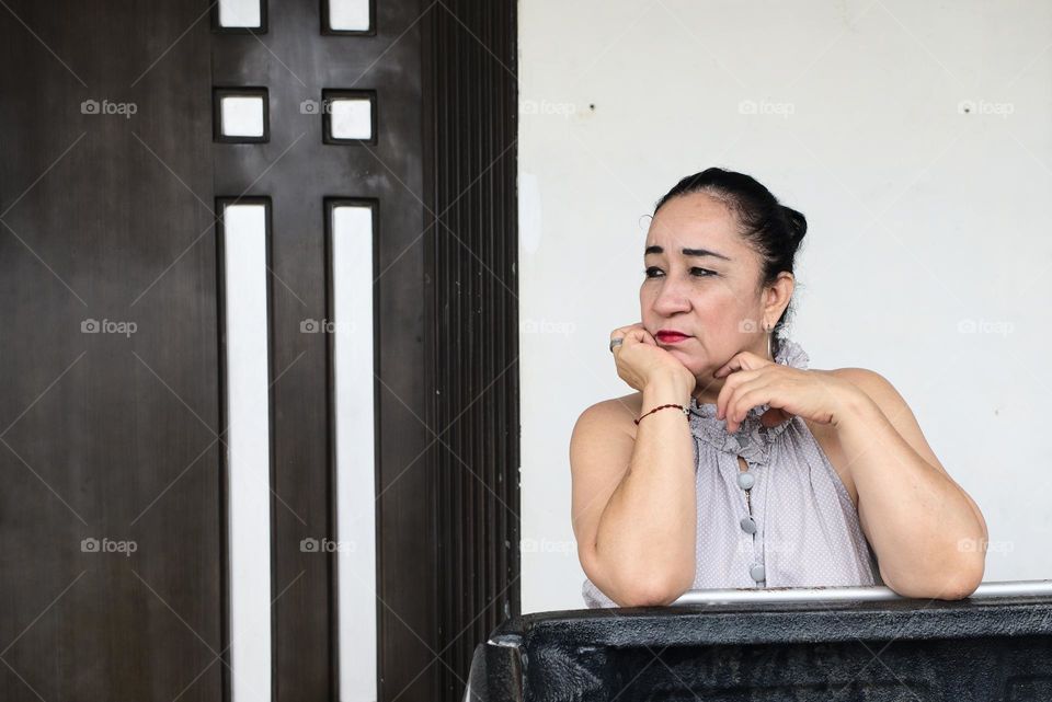 Thoughtful woman looking at the street during the day