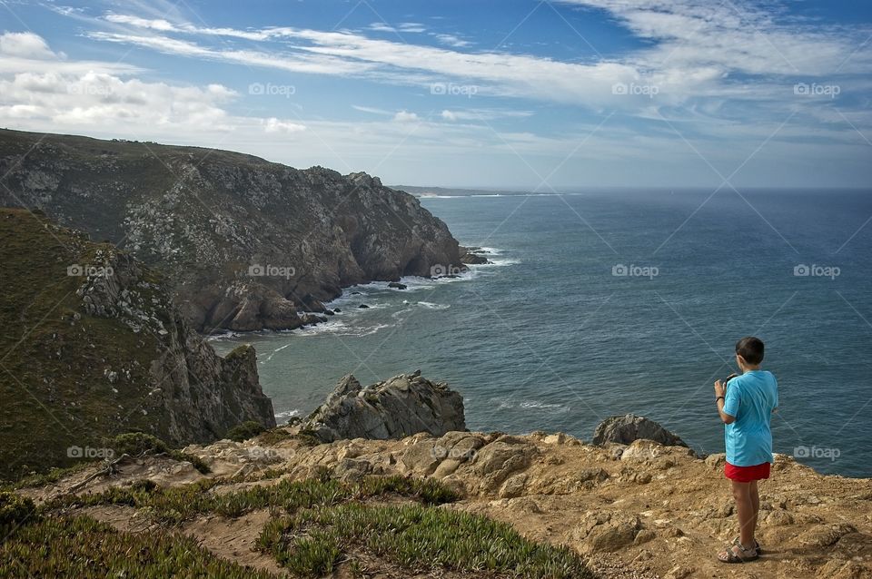 Boy looking at the cliffs 