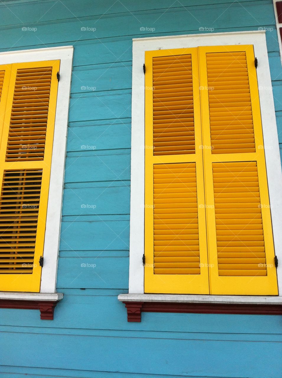 New Orleans. Yellow shutters on a blue house in New Orleans, Louisiana. 