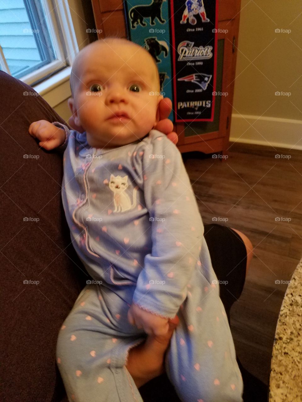 Baby 2 months old dressed in "kitty onesie".