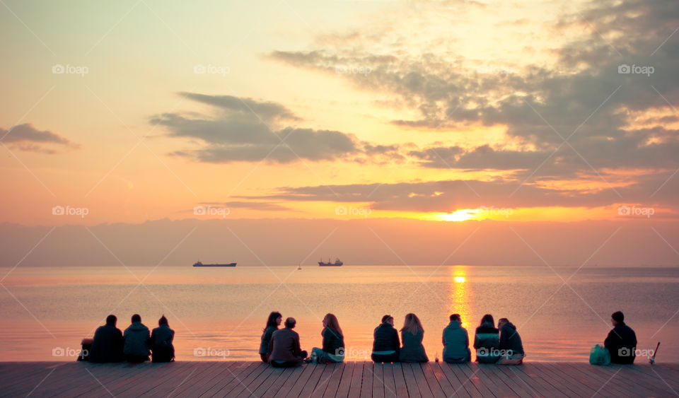 People At The Dock Enjoying The Sunset
