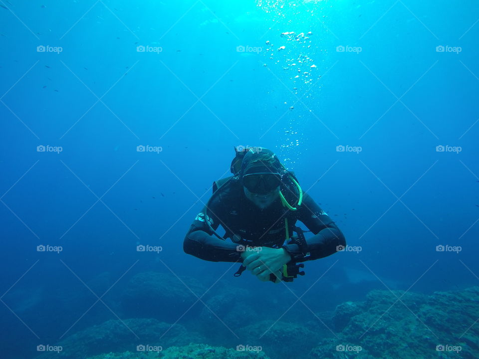 Diver hovering in blue water